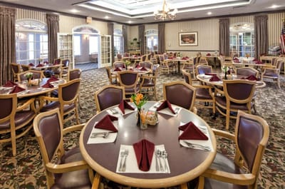 Dining room set for a meal with elegant table settings