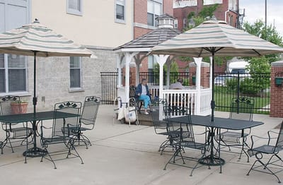 Resident relaxing in a gazebo in the garden area
