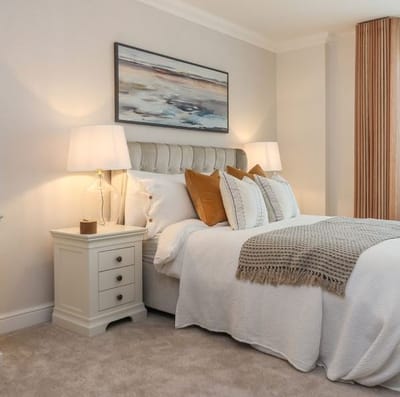A well-decorated bedroom with a cozy bed and artwork