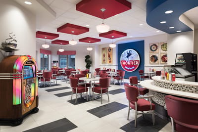 Bright dining area with seating and a jukebox