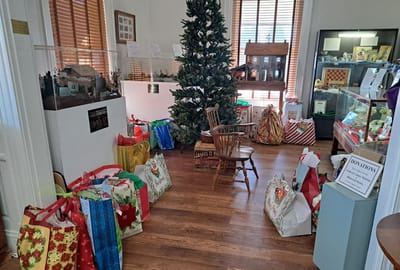 Decorated indoor space with holiday gifts and a tree