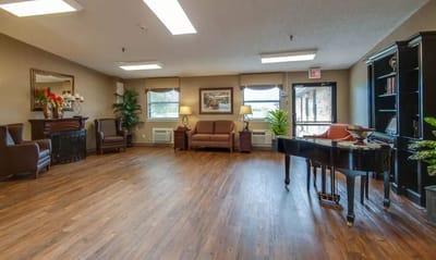 Bright common area with seating and piano
