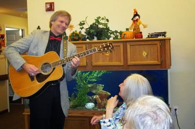 Musician performing for residents in a common area
