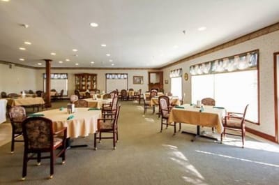 Dining room with tables and chairs set for meals