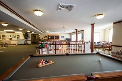 A common area with a pool table and seating