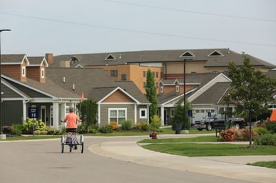 A resident biking through the community streets.