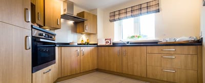 A bright kitchen area with wooden cabinetry