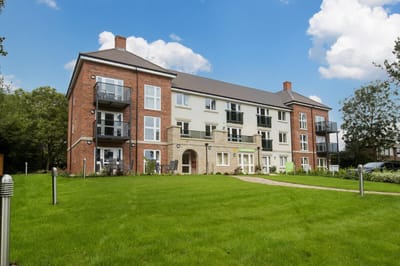 Exterior view of assisted living building surrounded by lawn