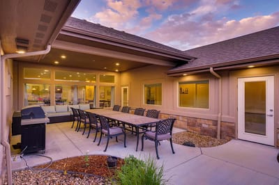 Outdoor patio area with seating and grill