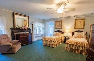 Cozy bedroom setup with two beds and decorative elements