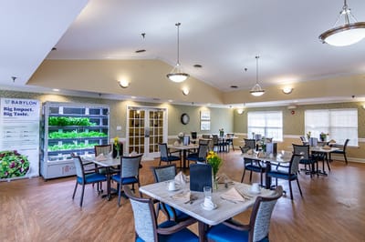 Dining room setup with plates and flowers on tables
