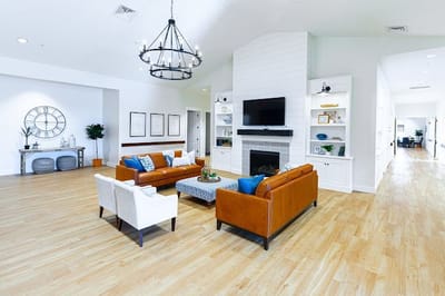 Bright common area with seating and fireplace