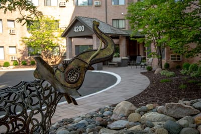 Outdoor courtyard with a sculpture and building entrance