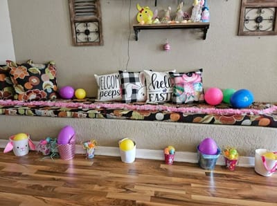 Decorative display with festive pillows and colorful Easter eggs