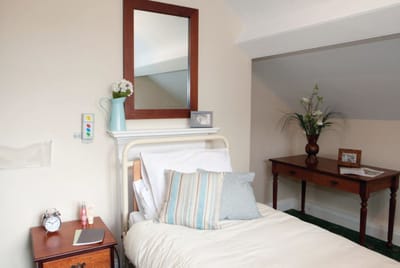 Cozy resident room with bedside table and decor