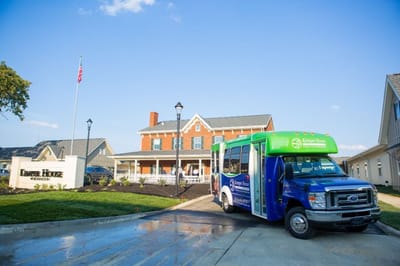 Facility shuttle parked in front of the building