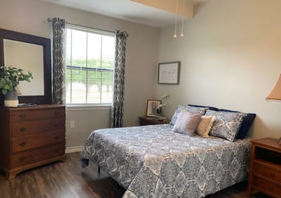 Cozy bedroom with a neatly made bed and furnishings