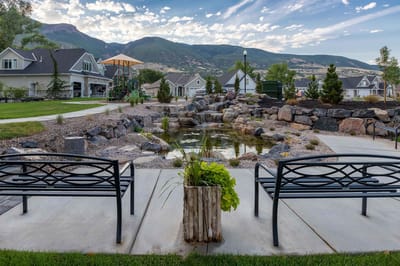 Outdoor garden area with benches and water feature