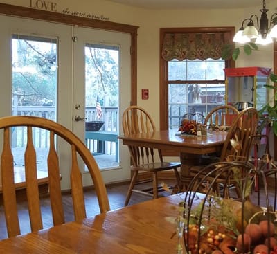 Cozy common area with wooden tables and chairs