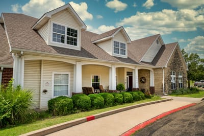 Exterior view of Creekside Village facility with gardens