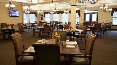 Dining room set up for residents with flowers on tables