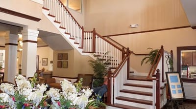 Interior view of a welcoming lobby with a staircase
