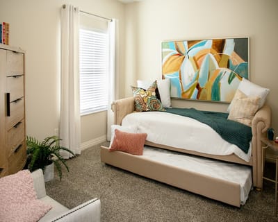 Cozy interior of a resident's room with a daybed and decor