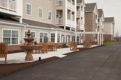 Outdoor seating area with fountain at a senior living facility