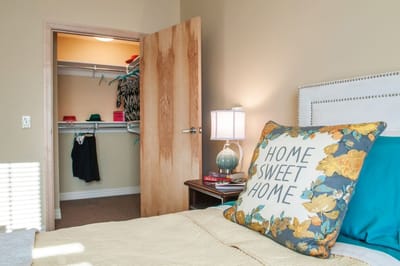 Cozy bedroom with 'Home Sweet Home' pillow
