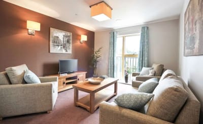 Cozy lounge area with comfortable seating and a TV