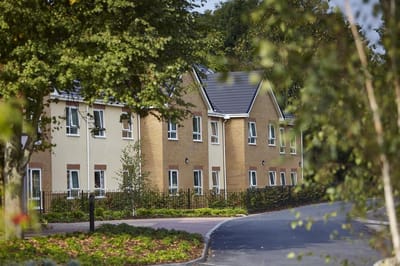 Exterior view of Derby Heights Care Home surrounded by greenery