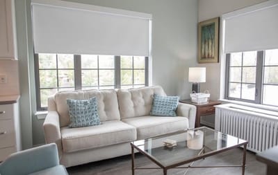 Cozy interior living area with a sofa and windows