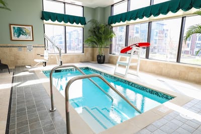 Indoor swimming pool area with large windows