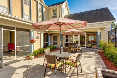 Outdoor seating area with tables and umbrellas