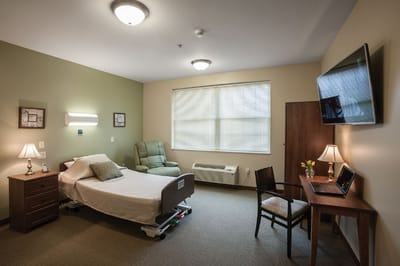 Cozy resident room with a bed and recliner