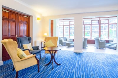 Bright common area with seating and large windows