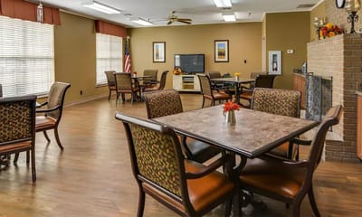 Common area with tables and seating in a cozy lounge