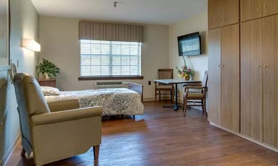 Private resident room with a bed and seating area
