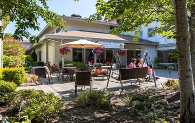 Outdoor seating area with residents enjoying the garden