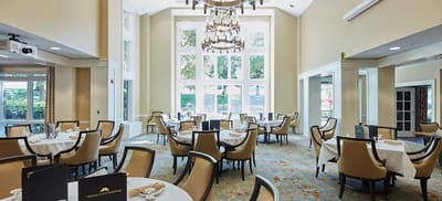 Bright dining room with large windows and elegant tables