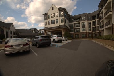 Exterior view of Fleming Farms Senior Living with parking area
