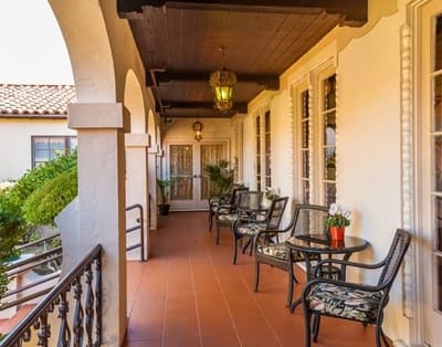 Covered patio area with seating and plants