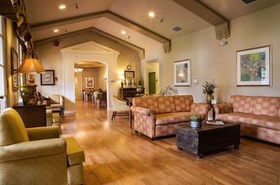 Common area with seating and decor in a senior living facility