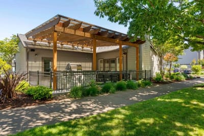 Outdoor patio area with seating and greenery