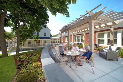 Residents enjoying outdoor seating at the facility