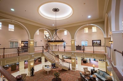 Interior view of a spacious common area with a grand staircase