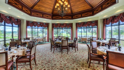 Elegant dining room with large windows and decorative lighting