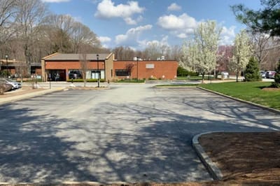 Exterior view of the facility with landscaped grounds