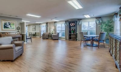 Bright common area with seating and a piano