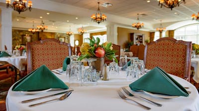 Elegantly set dining table in a facility dining room